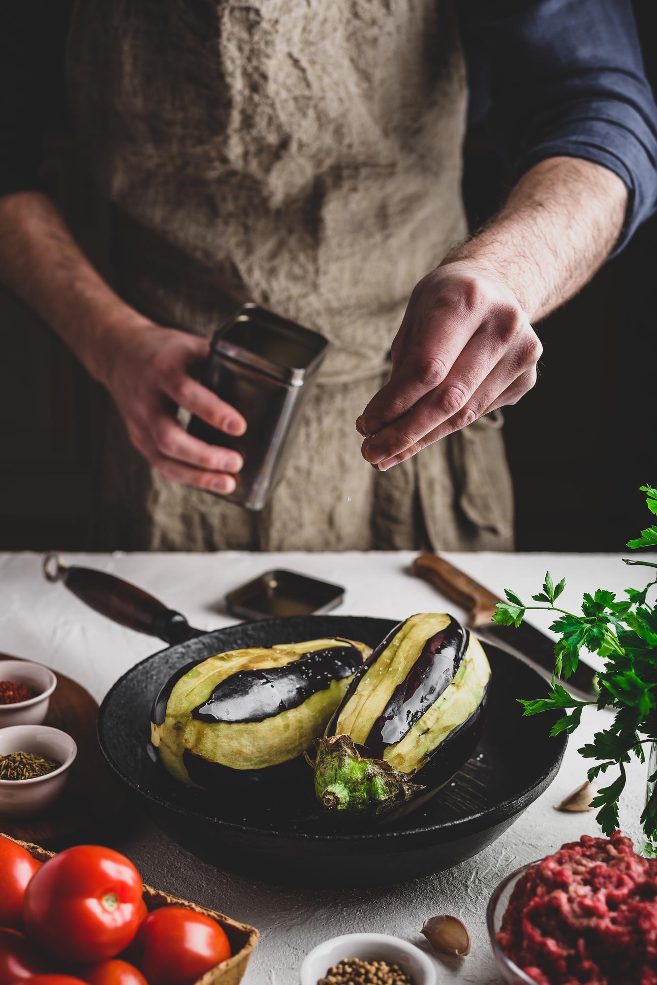 Local chef preparing heritage dish in modern kitchen